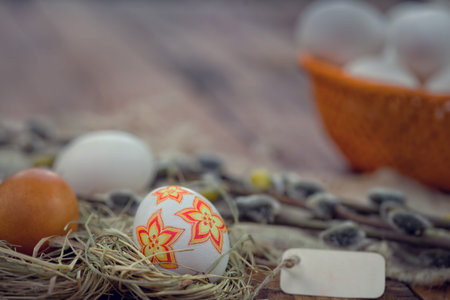 Decoupage Easter eggs in nest on rustic wooden backgroundの写真素材