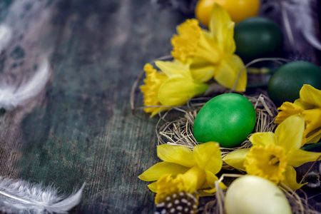 Colorful Easter eggs in the nest on the old wooden backgroundの写真素材