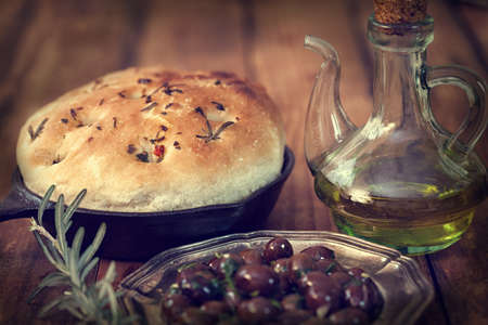 Italian Focaccia bread with rosemary and olivesの写真素材