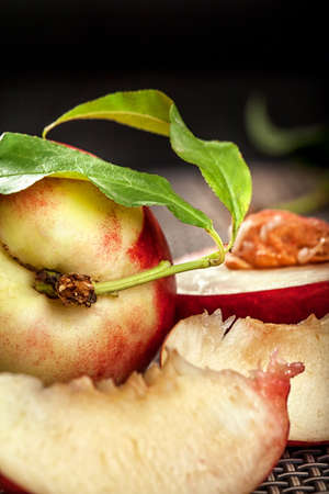 Fresh organic peaches in front of black background with copy spaceの写真素材