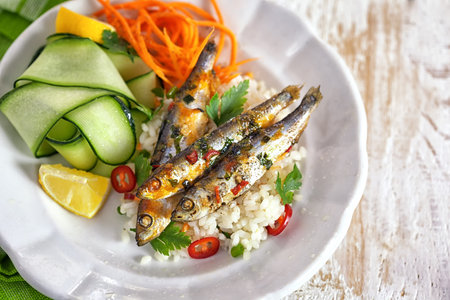 Grilled sardines with zucchini and lemonの写真素材