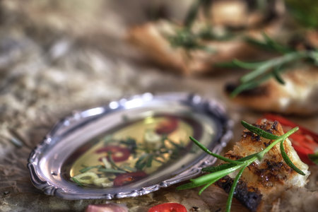 Italian Antipasto - Appetizers with olive oil and herbs close up