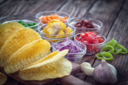 Mexican corn tortilla tacos with vegetables on wooden backgroundの写真素材