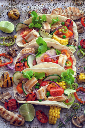 Mexican corn tortilla tacos with vegetables and chicken