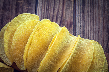 Tacos - Mexican yellow corn tortilla, empty shell on wooden cutting boardの写真素材