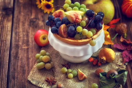 Autumn concept - Autumn fresh fruit on wooden background with copy spaceの写真素材