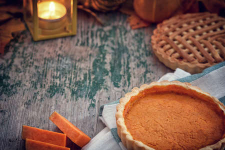 Thanksgiving pumpkin pie on wooden backgroundの写真素材