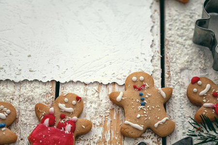 Christmas wooden background with gingerbread and snow