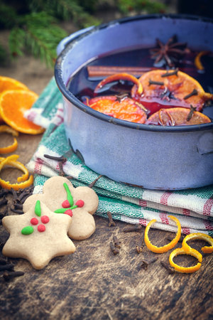 Mulled wine with spices and ingredients on wooden backgroundの写真素材