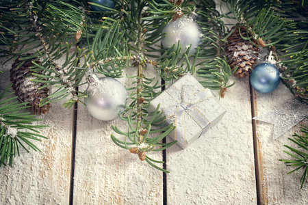 Christmas garland on rustic white wooden table with copy spaceの写真素材
