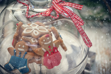 Christmas Gingerbread cookie on glass stand with snow flakesの写真素材