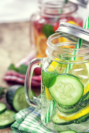 Detox Infused water with cucumber and lemon on wooden backgroundの写真素材