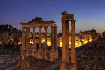 Blue hour at the Forum Romanum with temple of Saturn and of Vespasian and Titus, Rome, Italyの写真素材