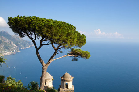 Amalfi coast as seen from Ravello with a tree and a church in the foreground, Revello, Italy
