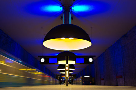 Subway station with incoming trains and symmetric yellow lights