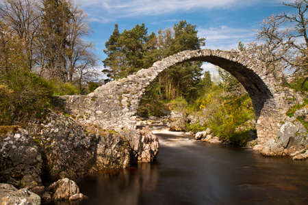 Medieval Stone Bridge over a river, Carrbridge, Scotlandの写真素材