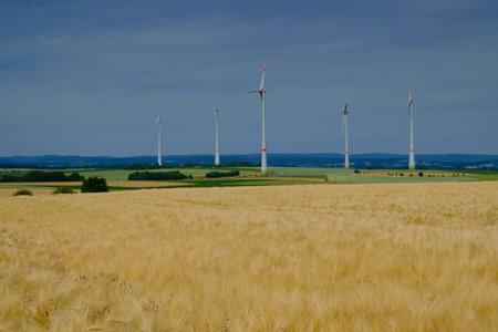 Golden wheat field and wind turbines Hohe Strasse Wetterau Germanyの写真素材