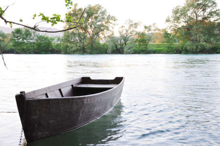 Old rowing boat on the riverの写真素材