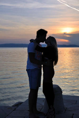 Couple embracing in love on sunsetの写真素材