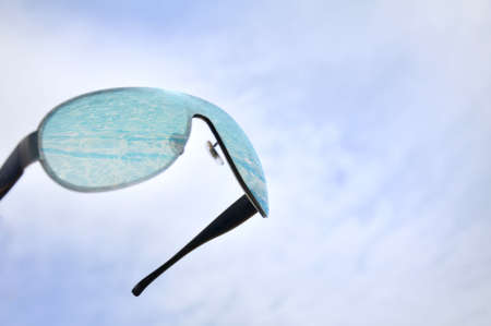 Black sun glasses and skyの写真素材