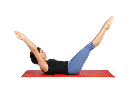 Fit young female pilates instructor showing different exercises on a white background の写真素材