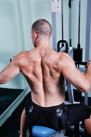 Muscular man exercising in a gym