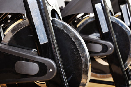 Group of spinning bicycles at fitness studio