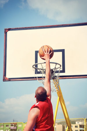 Basketball player in action flying high and scoring