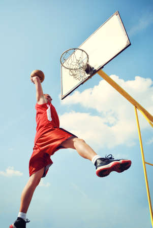 Basketball player in action flying high and scoringの写真素材
