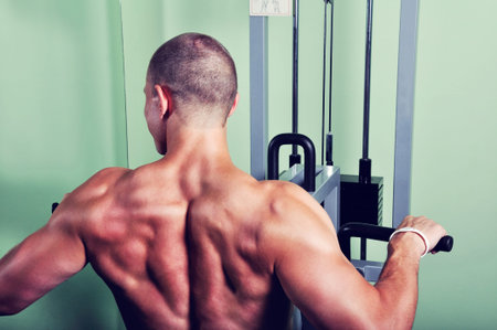 Muscular man exercising in a gym