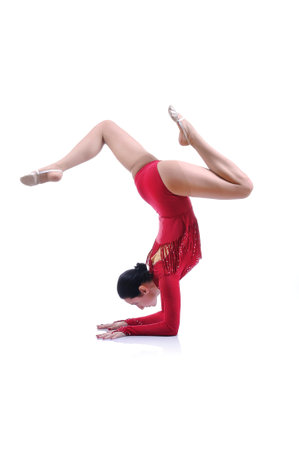 Beautiful artistic female gymnast working out, performing art gymnastics element
