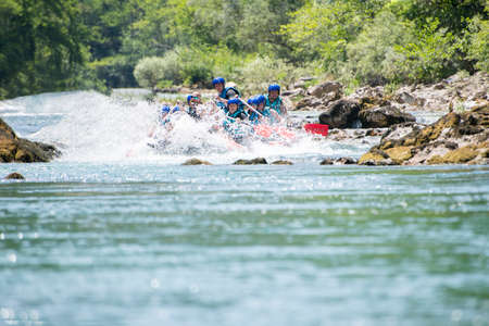 Rafting team goes down the river on the beautiful sunny day.の写真素材
