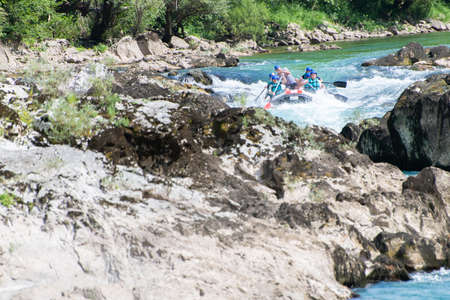 Rafting team goes down the river on the beautiful sunny day.の写真素材
