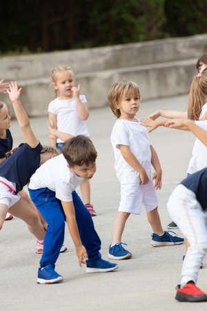 Close up of children group warming up and preparing for the main part of lesson.の写真素材