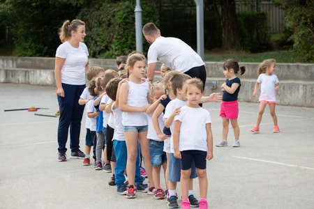 Group of children standing in column and waiting for lesson start.  Sport schoolの写真素材