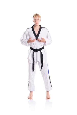 Handsome caucasian taekwondo fighter posing isolated on white backgroundの写真素材