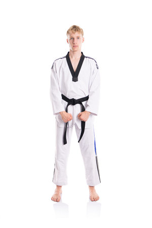 Handsome caucasian taekwondo fighter posing isolated on white backgroundの写真素材