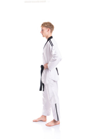 Handsome caucasian taekwondo fighter posing isolated on white backgroundの写真素材