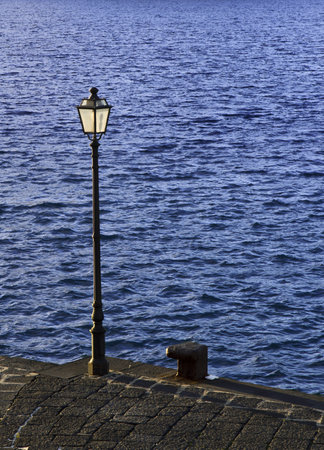lamp post by the seaの写真素材