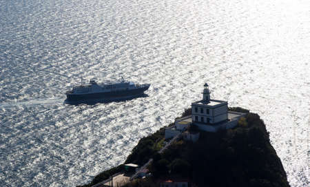 ship and lighthouse at capo miseno baiaの写真素材