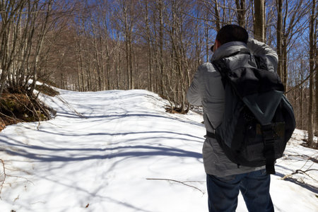 hiker on mountain trail with snow in matese park