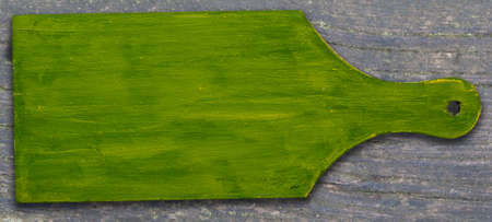 green cutting board on wooden backgroundの写真素材