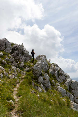 woman hiker on green mountainの写真素材