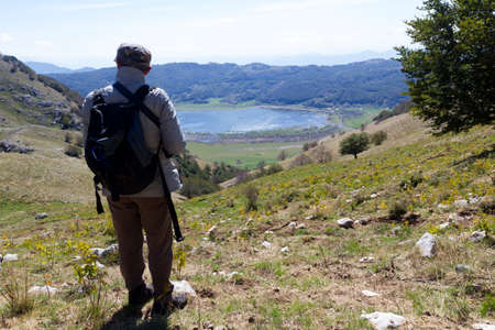 hiker on mountain peak and lake mateseの写真素材