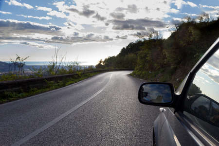 auto stops on mountain road rear-view mirror の写真素材