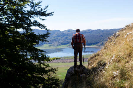 hiker on mountain peak and lake mateseの写真素材