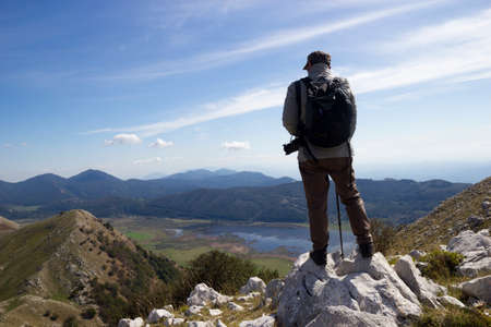 hiker on mountain peak and lake mateseの写真素材