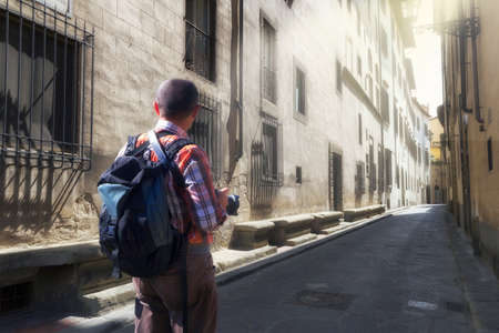 tourist with backpack in a florence streetの写真素材