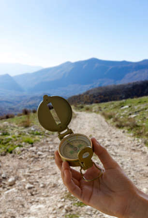 compass in hand and mountain backgroundの写真素材