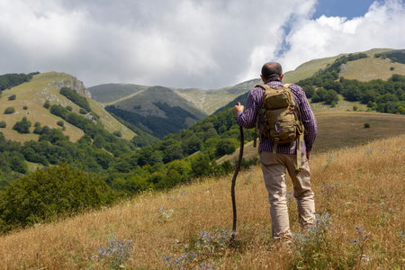 Hiker on the summit of a mountainの写真素材